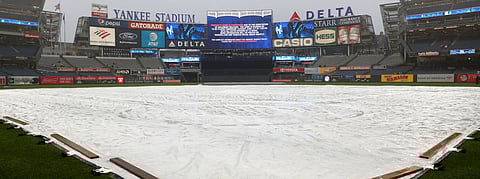 Yankee Stadium field is covered by a tarp as rain falls before June 10 game is postponed (Kathy Willens)