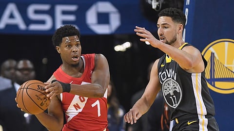 Toronto Raptors guard Kyle Lowry (7) passes the ball in front of Golden State Warriors guard Klay Thompson (11) during the first half of Game 6 of basketball’s NBA Finals, Thursday, June 13, 2019, in Oakland, Calif. (Frank Gunn/The Canadian Press via AP)