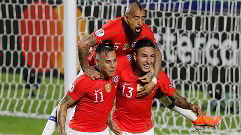 Chile’s Erick Pulgar (bottom right) celebrates scoring a goal goal with teammates Eduardo Vargas (left) and Arturo Vidal during a Copa America Group C match on June 17 (Nelson Antoine)