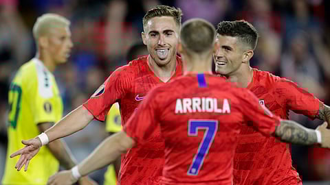 United States’ Tyler Boyd (facing camera) celebrates with teammates Paul Arriola (7) and Christian Pulisic as Guyana’s Matthew Briggs walks away during the second half on June 18 (Andy Clayton-King)