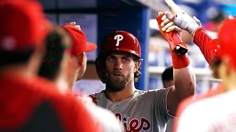 Phillies’ Bryce Harper greets teammates in dugout after scoring during the sixth inning on June 30 (Brynn Anderson)