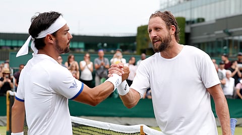 United States’ Tennys Sandgren, right, greets Italy’s Fabio Fognini at the net after winning their Men’s singles match during day six of the Wimbledon Tennis Championships in London, Saturday, July 6, 2019. (AP Photo/Alastair Grant)