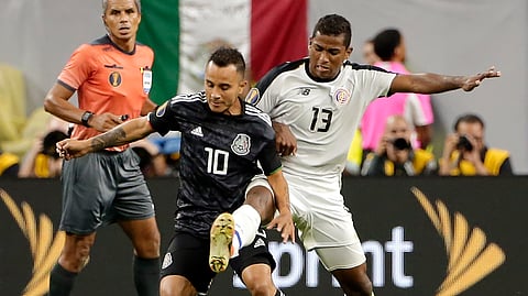 Mexico midfielder Luis Montes (10) works to keep control of the ball from Costa Rica midfielder Allan Cruz (13) during the extra time period of their CONCACAF Gold Cup quarterfinal soccer match Saturday, June 29, 2019, in Houston. (AP Photo/Michael Wyke)