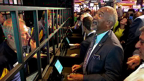 State Assemblyman Gary Pretlow, D-Westchester County, places a bet at Rivers Casino and Resort, Tuesday, July 16, 2019, in Schenectady, N.Y. New York joined the growing list of states allowing wagering on sports after the upstate casino cut the ribbon on a new betting lounge Tuesday and took its first bet — $20 on the Seattle Mariners. (AP Photo/David Klepper)