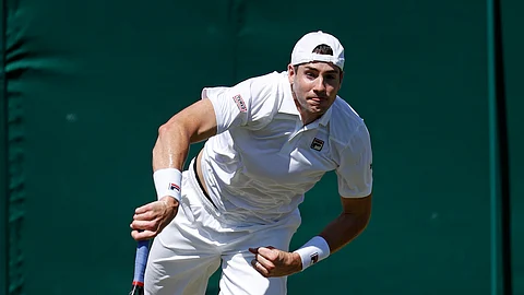 United States John Isner serves to Kazakhstan's Mikhail Kukushkin in a Men's singles match during day four of the Wimbledon Tennis Championships in London, Thursday, July 4, 2019. (AP Photo/Alastair Grant)