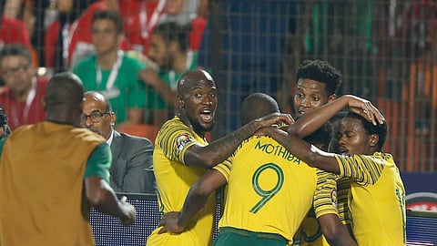 South African players celebrate after a goal during the African Cup of Nations round of 16 soccer match between Egypt and South Africa in Cairo International stadium in Cairo, Egypt, Saturday, July 6, 2019. (AP Photo/Ariel Schalit) 
