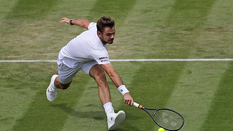 Switzerland’s Stan Wawrinka returns in his Men’s singles match against United States’ Reilly Opelka during day three of the Wimbledon Tennis Championships in London, Wednesday, July 3, 2019. (AP Photo/Ben Curtis)