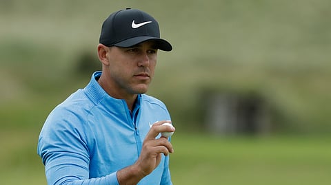 Brooks Koepka of the United States acknowledges the crowd after putting on the 12 the green during the third round of the British Open Golf Championships at Royal Portrush in Northern Ireland on July 20, 2019.
