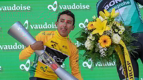 FILE - In this June 23, 2019 file photo, Egan Bernal from Colombia of Team Ineos lifts the trophy after winning the Tour de Suisse at the ninth and final stage. He’s one of the top contenders at cycling’s Tour de France which starts this weekend from Belgium. (Urs Flueeler/Keystone via AP, File)