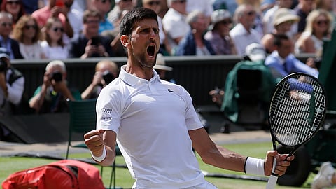Serbia's Novak Djokovic celebrates after beating Spain's Roberto Bautista Agut in a Men's singles semifinal match on day eleven of the Wimbledon Tennis Championships in London, Friday, July 12, 2019.