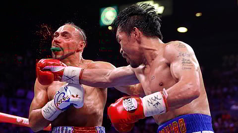 Manny Pacquiao, right, lands a punch against Keith Thurman in the fifth round during a welterweight title fight Saturday, July 20, 2019, in Las Vegas. (AP Photo/John Locher)