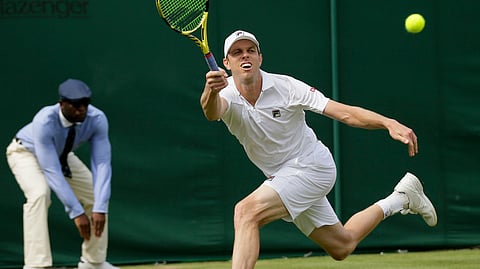 Sam Querrey serves to  Tennys Sandgren in a men’s singles match on July 8. Both me were once crowned national champions at Kalamazoo. (AP Photo/Tim Ireland)