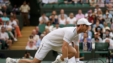 Britain’s Andy Murray prepares to return as he plays with his partner Pierre-Hugues Herbert in a Men’s doubles match during day four of the Wimbledon Tennis Championships in London, Thursday, July 4, 2019. (AP Photo/Tim Ireland)