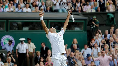 Switzerland's Roger Federer celebrates defeating Spain's Rafael Nadal during a men's singles semifinal match on day eleven of the Wimbledon Tennis Championships in London, Friday, July 12, 2019. (AP Photo/Ben Curtis)