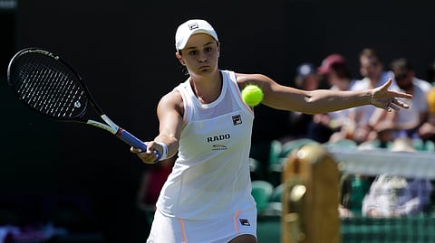 Australia’s Ashleigh Barty returns to Belgium’s Alison Van Uytvanck in a Women’s singles match during day four of the Wimbledon Tennis Championships in London, Thursday, July 4, 2019. 