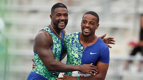 Isiah Young celebrates with Justin Gatlin, left, after winning his preliminary heat in the men's 100-meter dash at the U.S. Championships athletics meet, Thursday, July 25, 2019, in Des Moines, Iowa. (AP Photo/Charlie Neibergall)