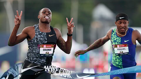 Christian Coleman celebrates in front of Michael Rodgers, right, as he wins the men's 100-meter dash final at the U.S. Championships athletics meet, Friday, July 26, 2019, in Des Moines, Iowa. (AP Photo/Charlie Neibergall)