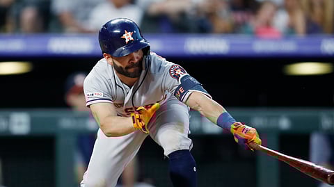 Astros’ Jose Altuve reaches out to connect for an RBI double off Rockies relief pitcher Bryan Shaw on July 2 (David Zalubowski)