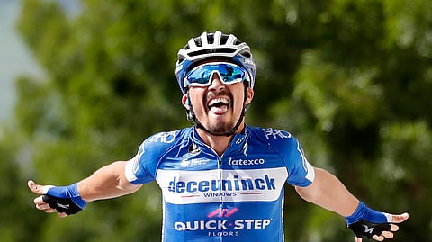 France’s Julian Alaphilippe celebrates as he crosses the finish line to win the third stage of the Tour de France cycling race over 215 kilometers (133,6 miles) with start in Binche and finish in Epernay, Monday, July 8, 2019. (AP Photo/Christophe Ena)