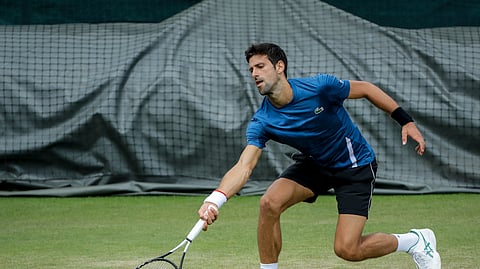 Serbia’s Novak Djokovic plays a practice session ahead of the Wimbledon Tennis Championships in London Sunday, June 30, 2019. (AP Photo/Ben Curtis)