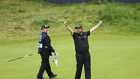 Ireland's Shane Lowry lifts his club to celebrate as he wins the British Open Golf Championships at Royal Portrush in Northern Ireland, Sunday, July 21, 2019.