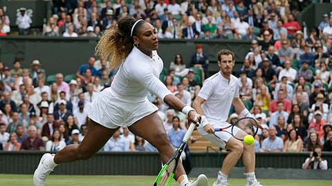 United States’ Serena Williams, left, is watched by playing partner Andy Murray as she plays a shot during a mixed doubles match during day six of the Wimbledon Tennis Championships in London, Saturday, July 6, 2019. (AP Photo/Tim Ireland)