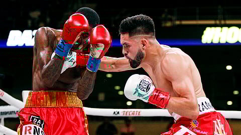 Jose Ramirez, right, lands a punch on Mauruce Hooker in the second round of a boxing match, Saturday, July 27, 2019, in Arlington, Texas. Ramirez won in the sixth round with a TKO. (AP Photo/Brandon Wade)