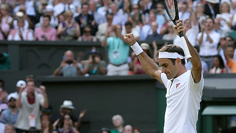 Switzerland's Roger Federer celebrates defeating Japan's Kei Nishikori during a men's quarterfinal match on day nine of the Wimbledon Tennis Championships in London, Wednesday, July 10, 2019. (AP Photo/Tim Ireland)