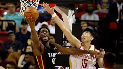 Miami Heat’s Yante Maten (0) lays up the ball against China’s Zhou Qi (15) during an NBA summer league basketball game Friday, July 5, 2019, in Las Vegas. (AP Photo/Steve Marcus)