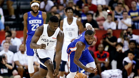 New Orleans Pelicans’ Zion Williamson, left, and New York Knicks’ Kadeem Allen chase the ball during an NBA summer league basketball game Friday, July 5, 2019, in Las Vegas. (AP Photo/Steve Marcus) 