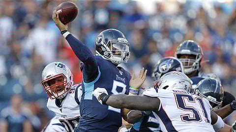 Tennessee Titans quarterback Marcus Mariota (8) passes as he is pressured by New England Patriots linebacker Ja'Whaun Bentley (51) in the first half of a preseason NFL football game on Aug. 17, 2019, in Nashville, Tenn.