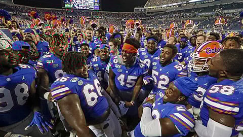 Florida players celebrate after defeating Miami 24-20 in an NCAA college football game Saturday, Aug. 24, 2019, in Orlando, Fla.