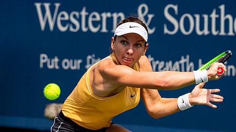 Simona Halep of Romania returns a serve from Ekaterina Alexandrova of Russia on Center Court at the Western & Southern Open Wednesday, Aug. 14, 2019 in Mason, Ohio. Halep advanced in three sets 3-6, 7-5, 6-4. (Meg Vogel/The Cincinnati Enquirer via AP)