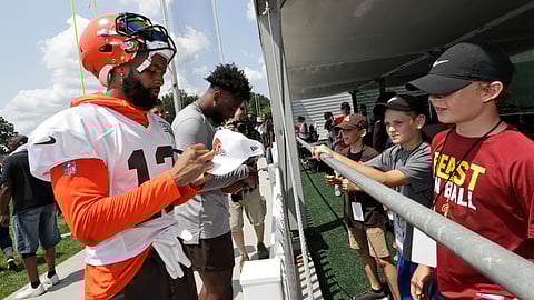 Cleveland Browns wide receiver Odell Beckham Jr. signs autographs after practice at the NFL football team's training camp facility on July 25, 2019 in Berea, Ohio.
