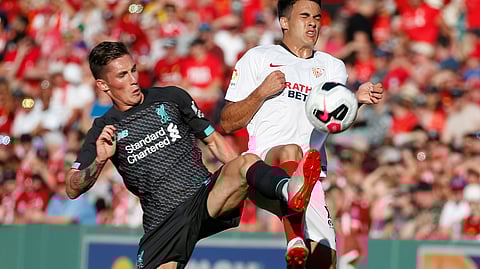 Liverpool's Harry Wilson, left, and Sevilla's Reguilon Rodriguez Sergio vie for the ball during the first half of a friendly soccer match at Fenway Park on July 21, 2019, in Boston.