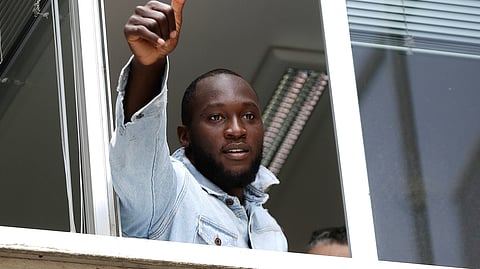 New Inter Milan forward Romelu Lukaku gives his thumbs up as he salutes Inter Milan supporters from a window of the Italian Olympic Committee's headquarters, in Milan, Italy on Thursday, Aug. 8, 2019.