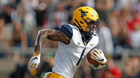 FILE - In this Sept. 29, 2018, file photo, West Virginia's T.J. Simmons runs downfield with the ball during the first half of the team's NCAA college football game against Texas Tech in Lubbock, Texas. Simmons is the top returning wide receiver on a unit that lost most of its production from last season. (AP Photo/Brad Tollefson, File)