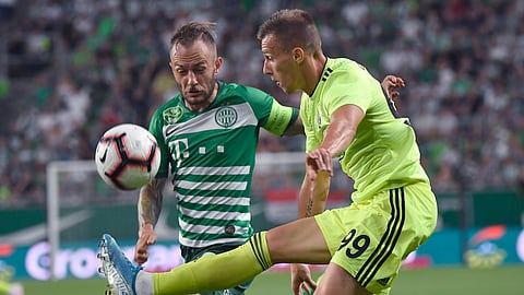 Ferencvaros' Gergely Lovrencsics, left, vies for the ball with Dinamo Zagreb's Mislav Orsic during the Champions League third qualifying round first leg soccer match between Ferencvaros and Dinamo Zagreb in Budapest, Hungary on Aug. 13, 2019.