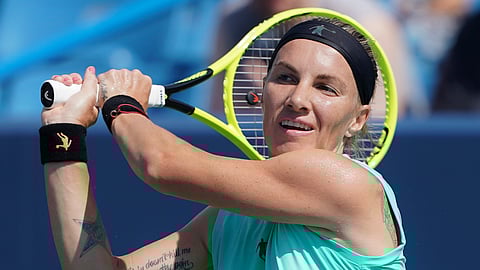 Svetlana Kuznetsova, of Russia, returns to Ashleigh Barty, of Australia, during the Western & Southern Open tennis tournament, Saturday, Aug. 17, 2019, in Mason, Ohio. (AP Photo/John Minchillo)