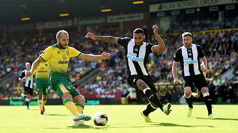 Norwich City's Teemu Pukki, left, has a shot on goal during the English Premier League soccer match between Norwich City and Newcastle United, at Carrow Road, in Norwich, England, Saturday, Aug.17, 2019.