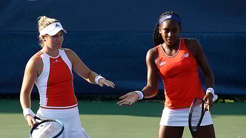 Caty McNally, left, slaps hands with Cori Gauff as they play the women's doubles final against Fanny Stollar, of Hungary, and Maria Sanchez at the Citi Open tennis tournament, Saturday, Aug. 3, 2019, in Washington.
