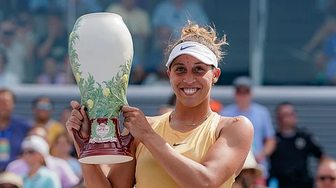 Madison Keys, of the United States, holds the Rookwood Cup after defeating Svetlana Kuznetsova, of Russia, in the women's final match during the Western & Southern Open tennis tournament Sunday, Aug. 18, 2019, in Mason, Ohio. (AP Photo/John Minchillo)