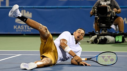 Nick Kyrgios, of Australia, rolls onto the court during a match in the Citi Open tennis tournament against Norbert Gombos, of Slovakia, Friday, Aug. 2, 2019, in Washington. (AP Photo/Nick Wass)