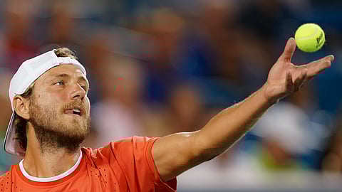 Lucas Pouille, of France, tosses the ball for a serve to Novak Djokovic, of Serbia, during the Western & Southern Open tennis tournament Friday, Aug. 16, 2019, in Mason, Ohio. (AP Photo/John Minchillo)
