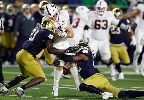 Notre Dame's Jalen Elliott (21) and Asmar Bilal make a tackle against Stanford on Sept. 29, 2018 (Carlos Osorio)