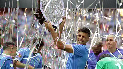 Manchester City's Rodri holds up the trophy after the English Community Shield soccer match between Liverpool and Manchester City at Wembley stadium in London, Sunday, Aug. 4, 2019.