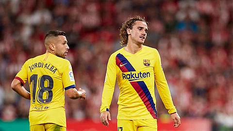 Barcelona's Antoine Griezmann, right, reacts during the Spanish La Liga soccer match between Athletic Bilbao and FC Barcelona at San Mames stadium in Bilbao, northern Spain, Friday, Aug. 16, 2019..