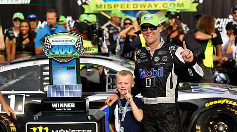 Kevin Harvick celebrates with his son, Keelan, after winning a NASCAR Cup Series auto race at Michigan International Speedway in Brooklyn, Mich., Sunday, Aug. 11, 2019. (AP Photo/Paul Sancya)