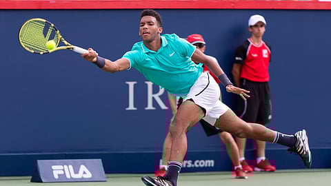Felix Auger-Aliassime of Canada lunges to return to compatriot Vasek Pospisil during a first round match at the Rogers Cup tennis tournament in Montreal, Tuesday, Aug. 6, 2019. (Paul Chiasson/The Canadian Press via AP)