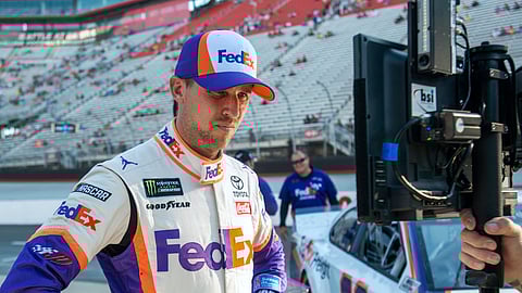 Denny Hamlin watches a television monitor as the last car qualifies for the NASCAR Cup Series auto race, Friday, Aug. 16, 2019, at Bristol Motor Speedway in Bristol, Tenn. Hamlin won the pole for Saturday night's race. (David Crigger/Bristol Herald Courier via AP)